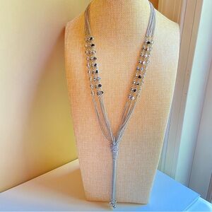 Matte silvertone knotted tassel necklace with faceted gray black crystal beads